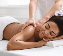 Woman receiving relaxing back massage at spa.