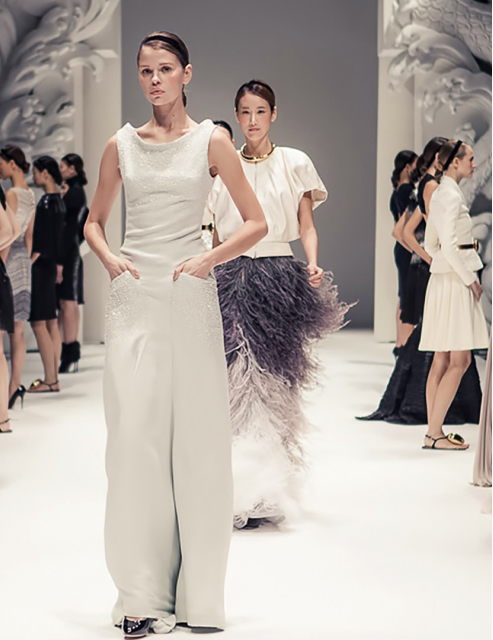Models walking on a fashion runway show.