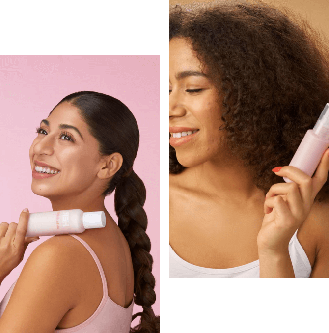 Women smiling with skincare products, pink background.