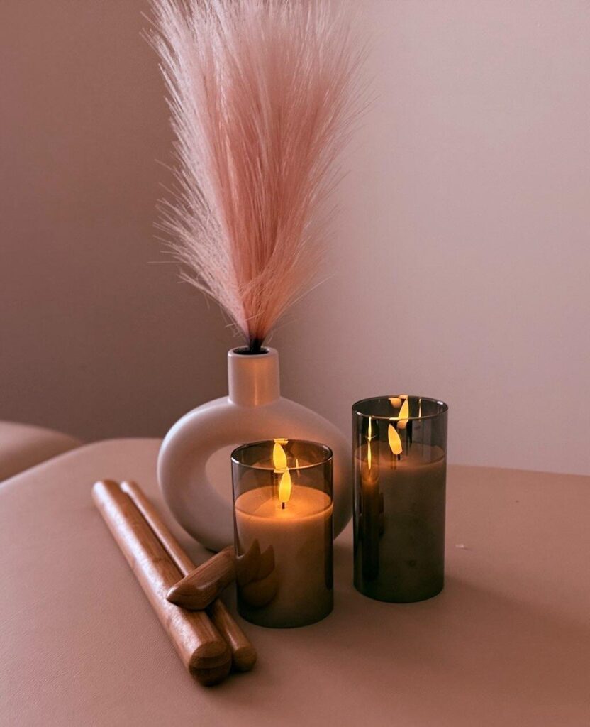 Candles and vase with decorative grass.