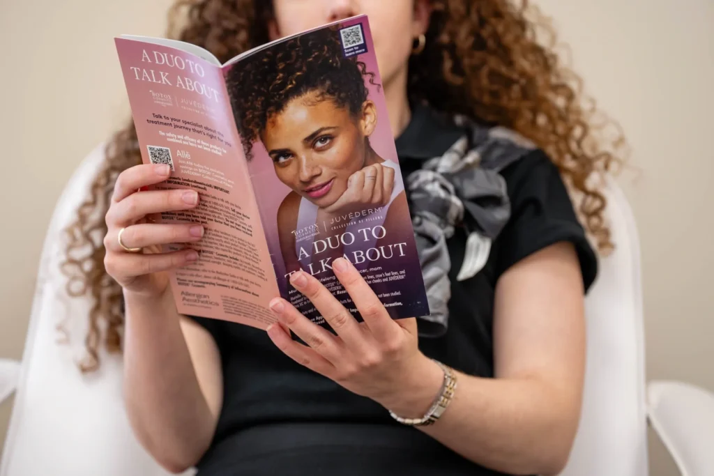 Person reading a beauty product brochure.