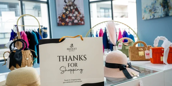 Shopping bag with hats and handbags display.