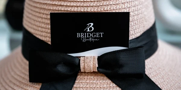 Straw hat with black ribbon and label.